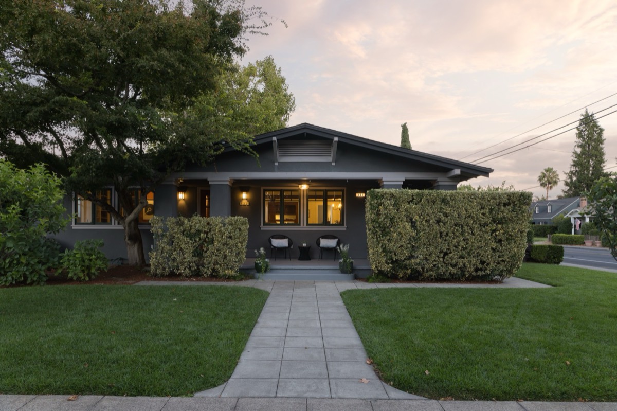 Front of 494 Fourth Street East at dusk, a Craftsman bungalow with porch lights on
